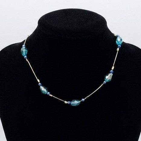 A blue floating bead chain necklace - choker length - displayed on a black jewellery stand